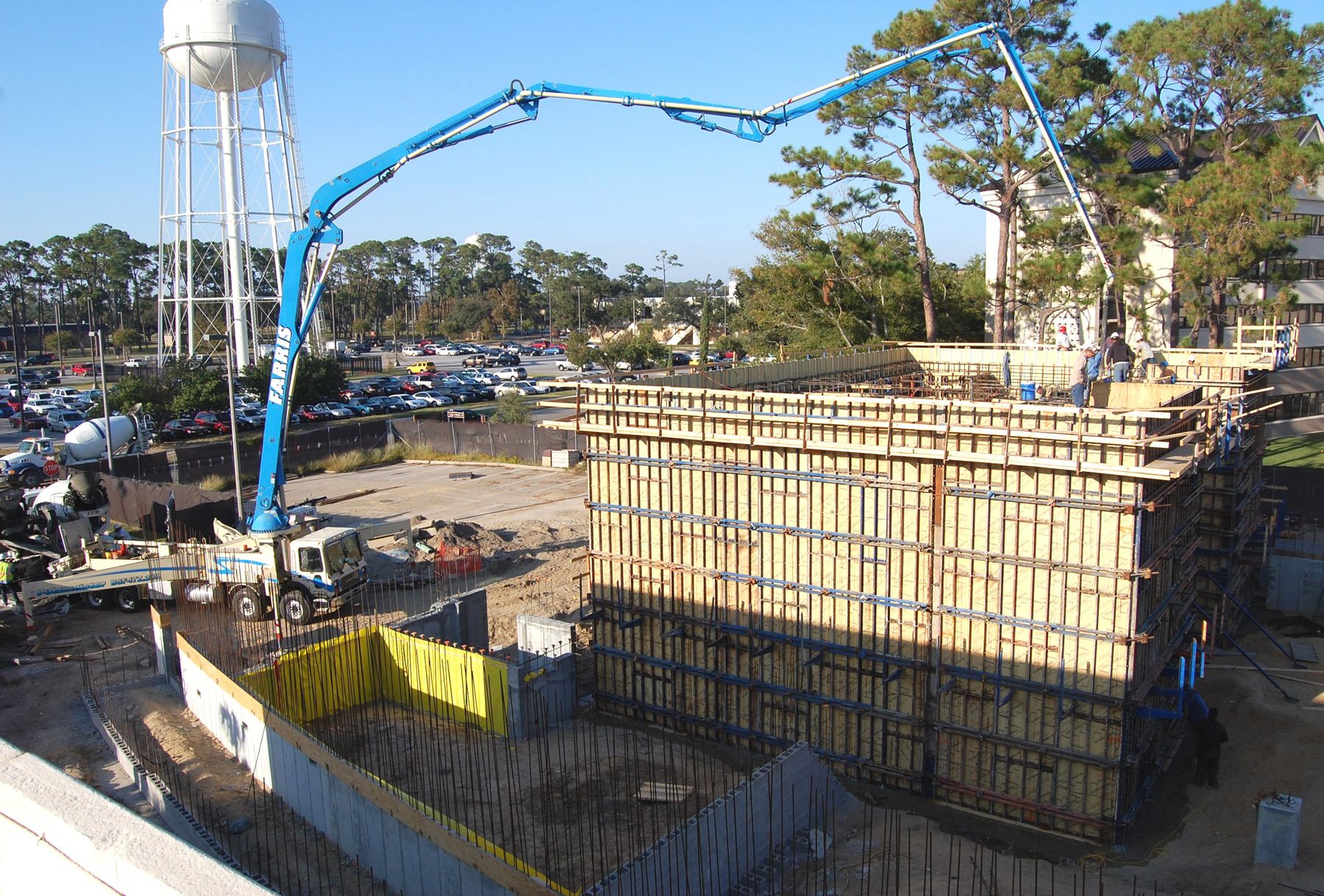 Concrete pump placing concrete at a building site